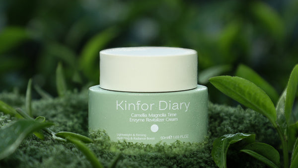 Green jar of Kinfor Diary cream on a grassy background